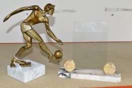 A MODERNIST FIGURE OF A FOOTBALLER, supported by a white marble plinth, together with a marble art