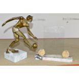 A MODERNIST FIGURE OF A FOOTBALLER, supported by a white marble plinth, together with a marble art