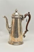 A GEORGIAN SILVER COFFEE POT, tall polished pot with engraved family crest, leaf detail to the spout