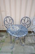 A BLACK PAINTED ALUMINIUM CIRCULAR GARDEN TABLE, diameter 62cm x height 71cm and two chairs (