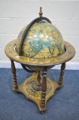 A MID TO LATE 20TH CENTURY DRINKS GLOBE, with a lid that's enclosing a fitted interior, on four