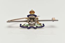 AN ENAMEL AND DIAMOND ROYAL ARTILLERY BROOCH, the cannon wheel set with single cut diamonds, with