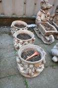 THREE WEATHERED COMPOSITE CIRCULAR PLANTERS, depicting cherubs to the side, diameter 29cm x height