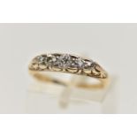 A YELLOW METAL FIVE STONE DIAMOND RING, set with five graduated old cut diamonds, each claw set in a