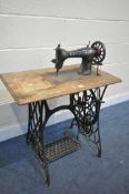 A SINGER TREADLE SEWING MACHINE (condition: -top with live woodworm)