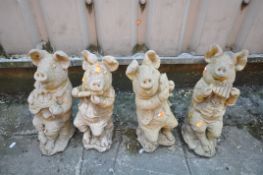 A SET OF FOUR COMPOSITE GARDEN FIGURES, of pigs playing various instruments (condition report: -