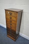 AN EARLY 20TH CENTURY OAK CHEST OF NINE DRAWERS, width 46cm x depth 38cm x height 117cm (