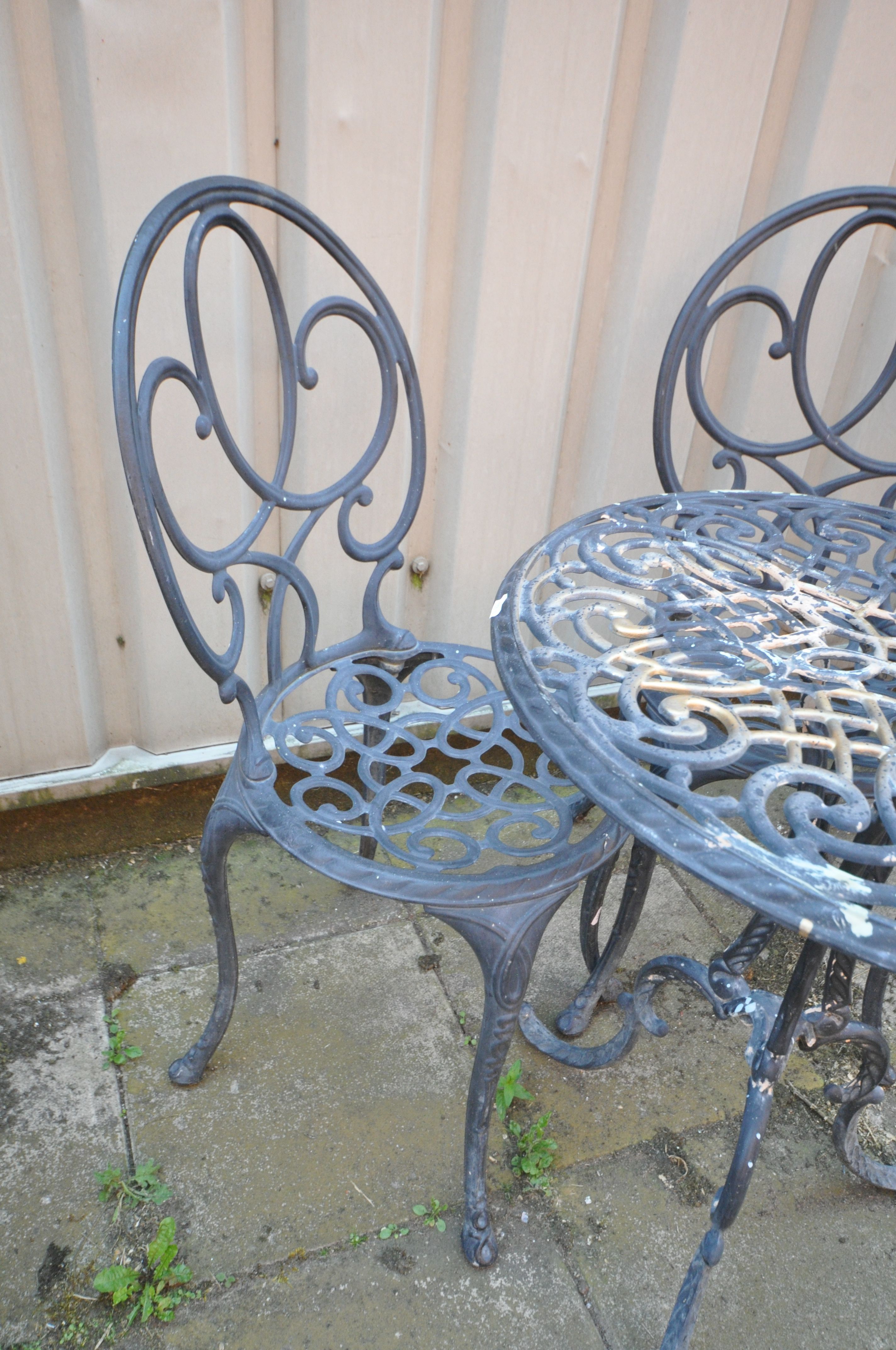 A BLACK PAINTED ALUMINIUM CIRCULAR GARDEN TABLE, diameter 62cm x height 71cm and two chairs ( - Image 2 of 2