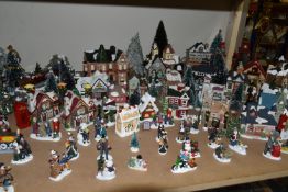A CHRISTMAS VILLAGE, approximately ninety to one hundred pieces, from various makers, scales and
