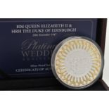 A PLATINUM WEDDING ANNIVERSARY SILVER PROOF 5OZ COIN, encased in a plastic capsule, together with