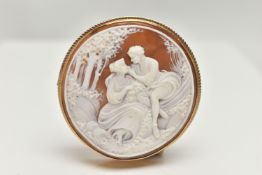 A 9CT GOLD CAMEO BROOCH, of a circular form, carved shell cameo depicting a couple scene, collet set