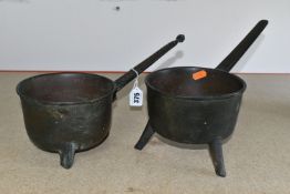 TWO BELL METAL TRIPOD SKILLETS, possibly late 17th century, worn inscriptions along both handles (2)