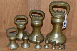 A COLLECTION OF TEN 20TH CENTURY BRASS BELL SHAPED WEIGHTS, ranging from 7lbs to 1/4oz (10)