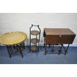AN EDWARDIAN MAHOGANY DROP LEAF TABLE, along with a folding cake stand, and a brass top folding