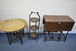 AN EDWARDIAN MAHOGANY DROP LEAF TABLE, along with a folding cake stand, and a brass top folding