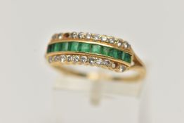 AN 18CT GOLD EMERALD AND DIAMOND RING, designed as a central line of nine square cut emeralds with a
