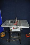 A PERFORMANCE FMTC-10TSW TABLE SAW on stand, parallel and mitre guide (PAT pass and working)