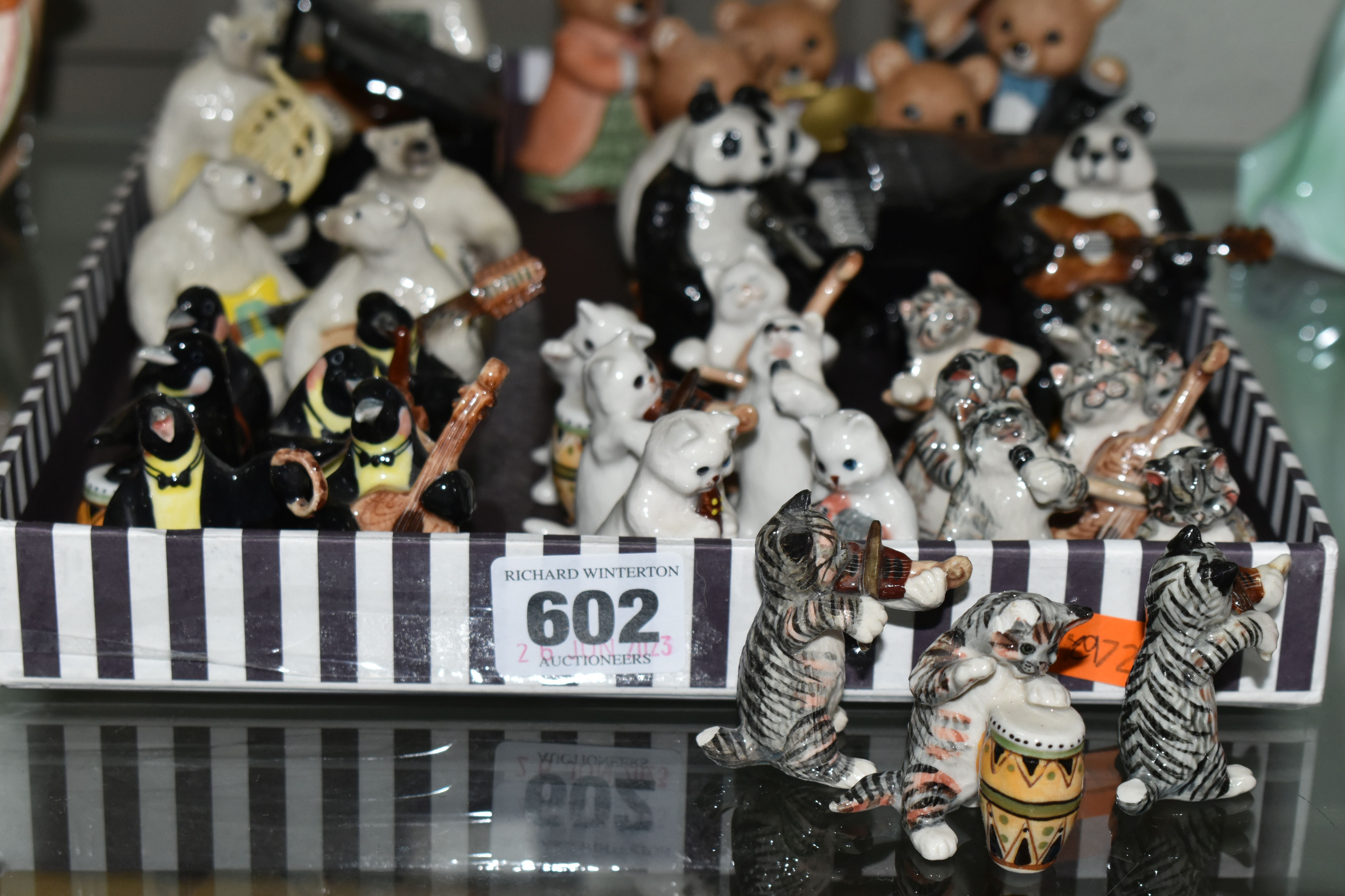 A TRAY OF MINIATURE CERAMIC ANIMAL MUSICIANS, comprising a six piece 'Penguin' band, ten piece '