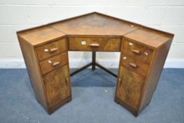 AN ART DECO CORNER DESK, with an arrangement of drawers, and two cupboard doors, width 89cm x