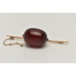 A CHERRY BAKELITE BEAD BROOCH, a large single, oval bead measuring approximately length 28.1mm x