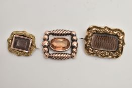THREE LATE VICTORIAN BROOCHES, two with central woven hair panels with scrolling acanthus leaf