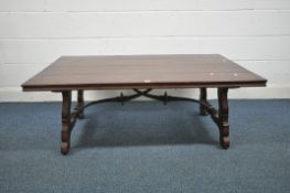 A RUSTIC SOLID MAHOGANY COFFEE TABLE, possibly Theodore Alexander, on a trestle base united by