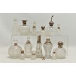 FOURTEEN LATE 19TH AND EARLY 20TH CENTURY SILVER MOUNTED SCENT BOTTLES, various shapes and sizes