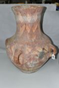 A PAINTED TERRACOTTA FOUR HANDLED URN, POSSIBLY CHINESE OF NEOLITHIC STYLE, decorated with geometric