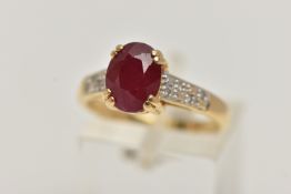 AN 18CT GOLD RUBY AND DIAMOND RING, set with an oval cut ruby, four claw set, flanked with single