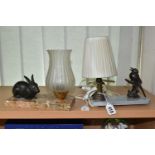TWO FIGURAL TABLE LAMPS, one depicting a songbird on a branch, surmounting a grey marble plinth,