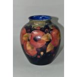 A MOORCROFT POTTERY BALUSTER VASE, tube lined Pomegranate pattern on a navy blue ground, painted and