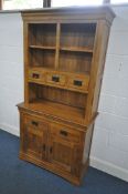 A SLIM GOLDEN SOLID OAK DRESSER, the top with three drawers and open shelving, over a base with