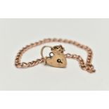 A 9CT GOLD CURB LINK BRACELET, fitted with a heart padlock clasp, clasp and chain hallmarked 9ct