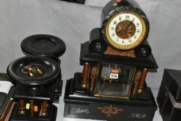 A LATE 19TH CENTURY BLACK SLATE AND GREEN MARBLE INSET CLOCK GARNITURE, the drum shaped clock with