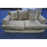 A BROWN UPHOLSTERED TWO SEATER SOFA BED