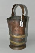 A COPPER AND BRASS JUG, with twin spouts, bucket style handle and brass applied decoration -