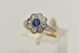 A YELLOW AND WHITE METAL CLUSTER RING, flower shape cluster set with a central circular cut sapphire