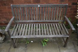 A TEAK SLATTED GARDEN BENCH