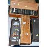 FOUR WOODEN TRAYS OF MAGIC LANTERN SLIDES AND TWO HOLDERS IN WOOD AND METAL, over three hundred