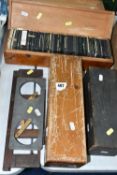 FOUR WOODEN TRAYS OF MAGIC LANTERN SLIDES AND TWO HOLDERS IN WOOD AND METAL, over three hundred