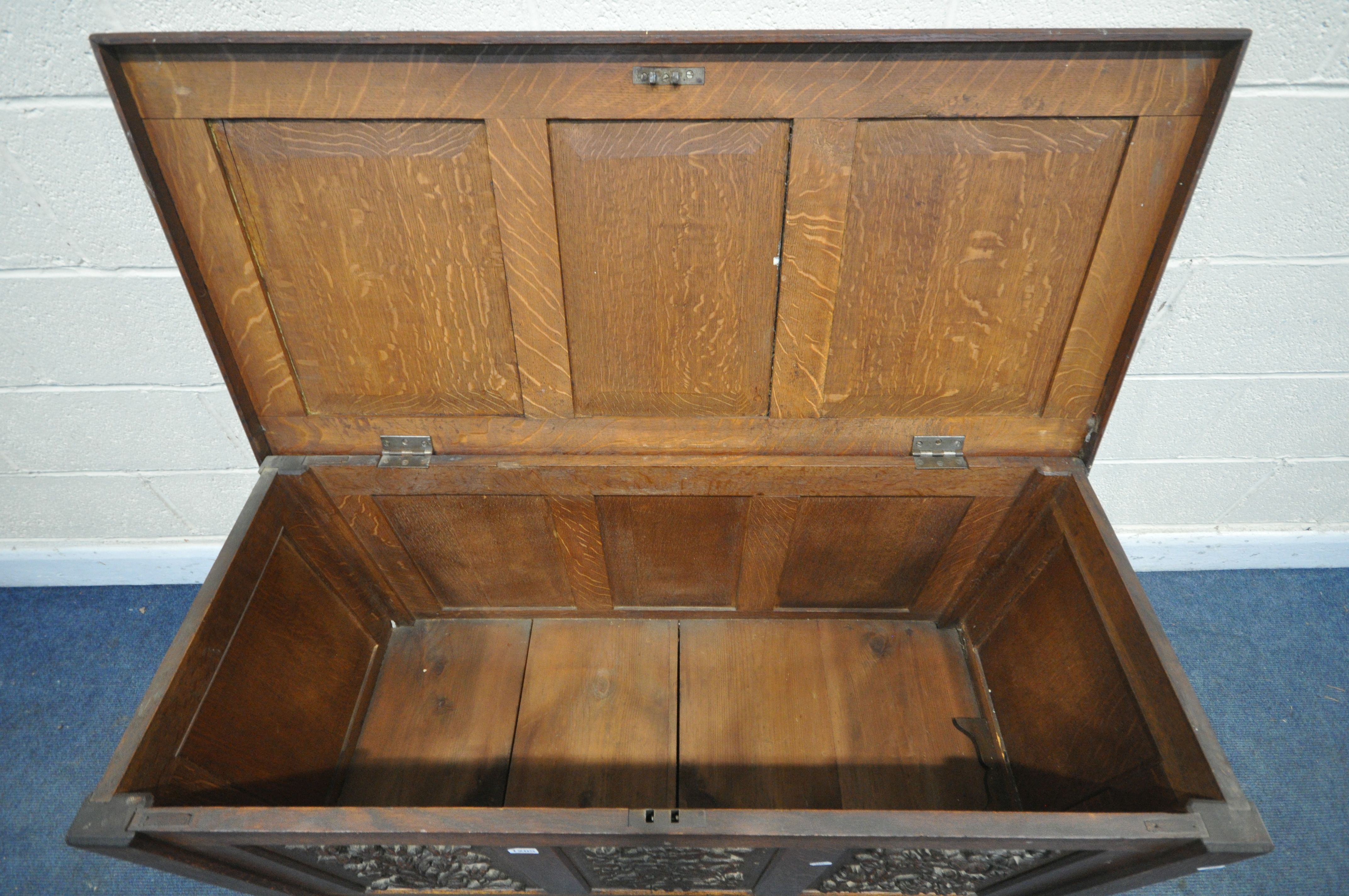 AN EARLY 20TH CENTURY OAK COFFER, decorated with nine foliate carved panels, width 122cm x depth - Image 6 of 6