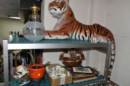 A LARGE TIGER SOFT TOY, brass oil lamp, basket of shells, framed prints, W.H. Goss Crested ware, a