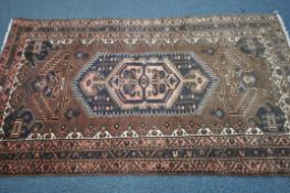 A BROWN WOOLLEN HERIZ RUG, 220cm x 107cm (condition report: -discoloured in parts)