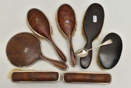 A SILVER AND IMITATION TORTOISESHELL DRESSING TABLE SET ETC., including four hair brushes and a hand