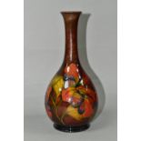 A MOORCROFT POTTERY FLAMBÉ HIBISCUS PATTERN VASE, with an elongated neck, tube lined pink, yellow