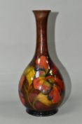 A MOORCROFT POTTERY FLAMBÉ HIBISCUS PATTERN VASE, with an elongated neck, tube lined pink, yellow