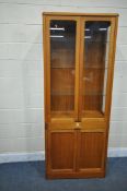 A MID CENTURY TEAK GLAZED BOOKCASE, enclosing three glass shelves, single drawer and double cupboard