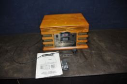 A STEEPLETONE EDINBURGH RETRO HI FI in oak veneered cabinet, remote and manual (PAT pass and working