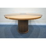 A SKOVBY OF DENMARK CIRCULAR DINING TABLE, with a winding mechanism revealing three additional
