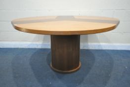A SKOVBY OF DENMARK CIRCULAR DINING TABLE, with a winding mechanism revealing three additional